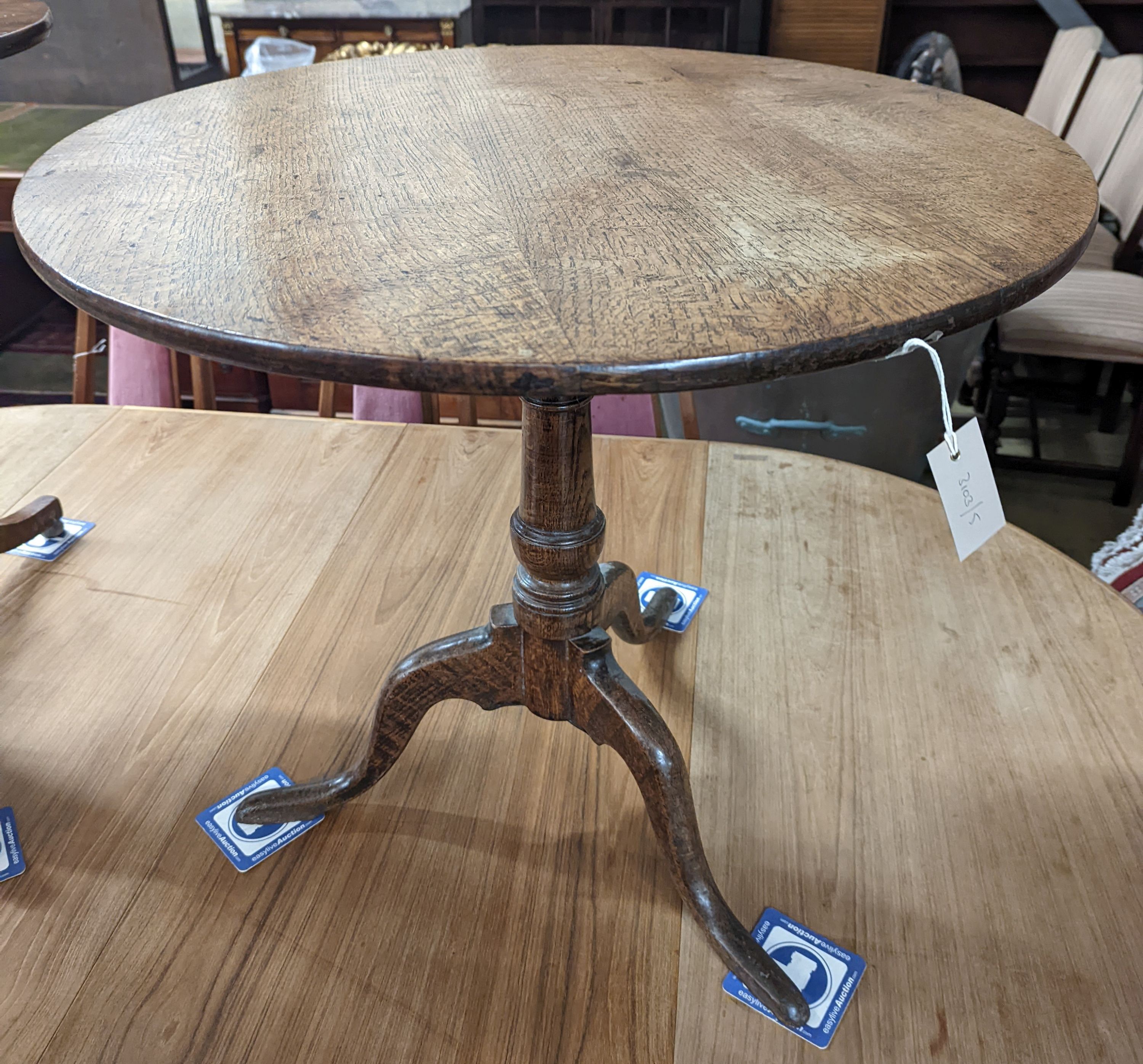A George III circular oak tilt top tea table, diameter 74cm, height 66cm